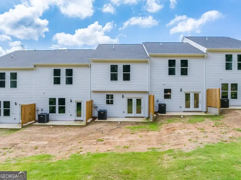 Exterior details and patio area of a home in Chimney Oaks Townhomes, Homer (Image 3).