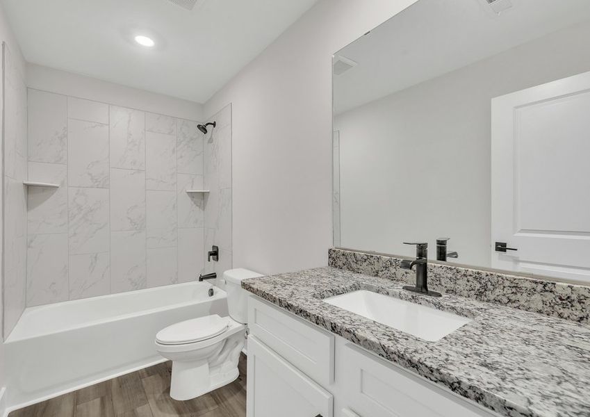 The secondary bathroom comes with a large soaking tub.