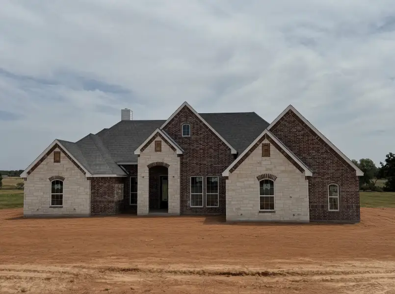 Front exterior of a new home in Overton Oaks, Paradise, TX, highlighting curb appeal (Image 1). Front exterior of a new home in Overton Oaks, Paradise, TX, highlighting curb appeal (Image 1).