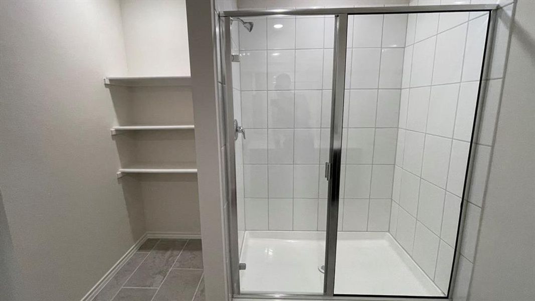 Walk-in shower with clear glass enclosure and white subway tile surround Walk-in shower with clear glass enclosure and white subway tile surround
