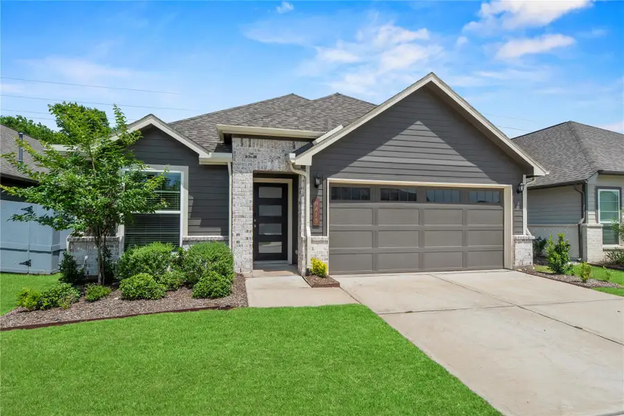 Welcome Home to 8415 Red Shiner Way! This is a modern single-story home with gray siding, a two-car garage, and neatly landscaped front yard. The house features a welcoming front porch and brick accents, offering a stylish curb appeal in a suburban setting.