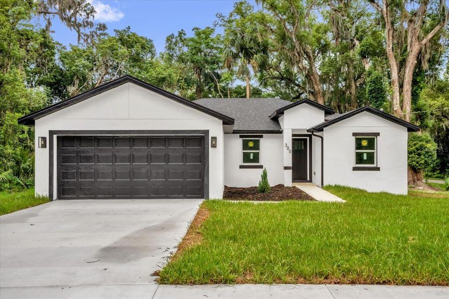 Front exterior of a new home in , Orange City, FL, highlighting curb appeal (Image 2). Front exterior of a new home in , Orange City, FL, highlighting curb appeal (Image 2).