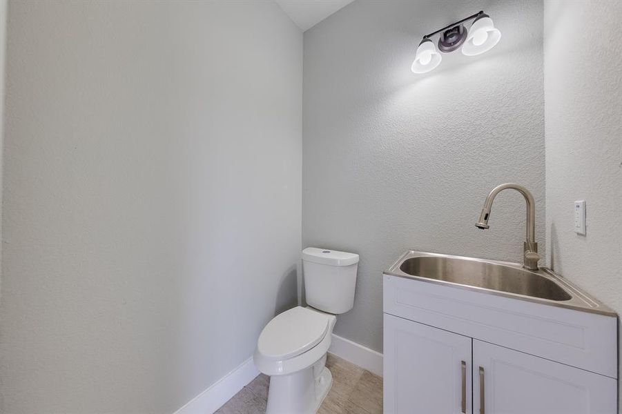 Mudroom or half bath conveniently located at the back patio, offering easy access and functionality for outdoor activities.