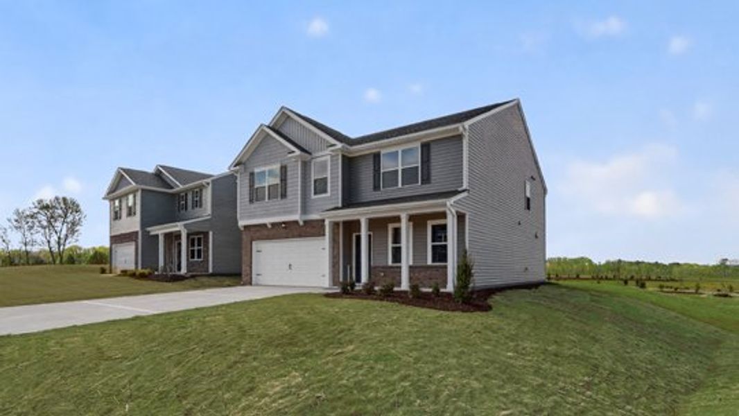 Front exterior of a new home in The Landing at Winston Pointe, Clayton, NC, highlighting curb appeal (Image 22). Front exterior of a new home in The Landing at Winston Pointe, Clayton, NC, highlighting curb appeal (Image 22).