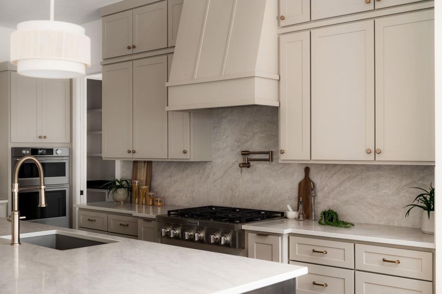 A well-appointed kitchen showcasing a sleek range, integrated appliances, and generous counter space.