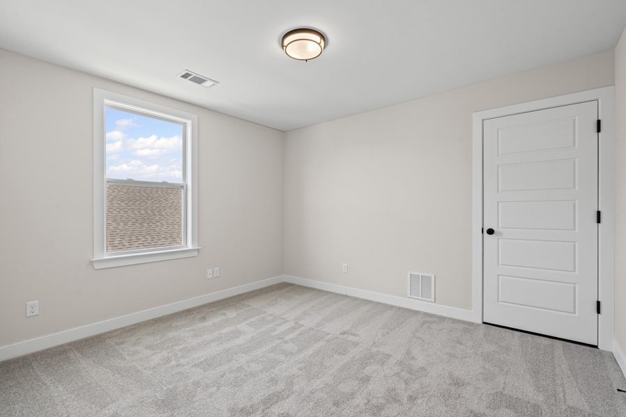 Spare room featuring baseboards and light carpet Spare room featuring baseboards and light carpet