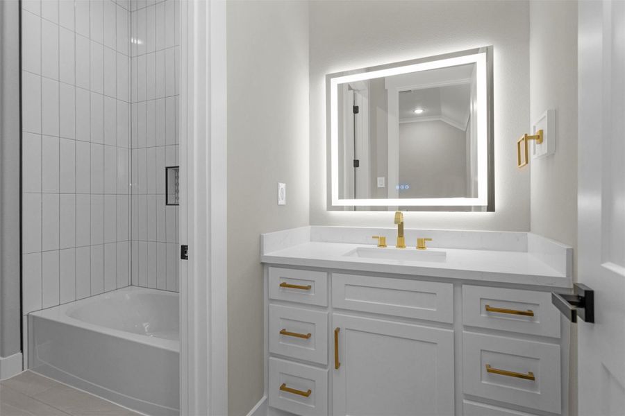 Full bathroom with walk in shower and backlit mirror. Full bathroom with walk in shower and backlit mirror.