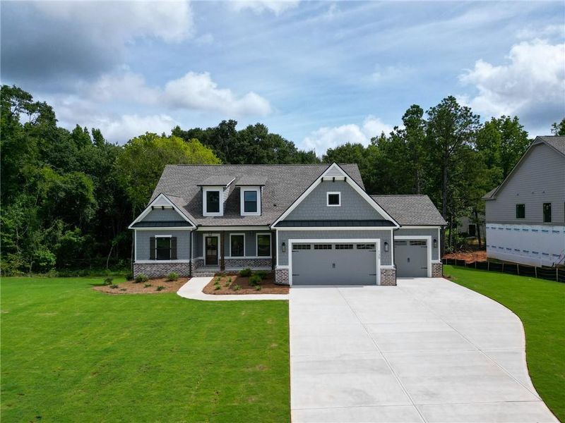 Front exterior of a new home in Riverwalk, Monroe, GA, highlighting curb appeal (Image 27). Front exterior of a new home in Riverwalk, Monroe, GA, highlighting curb appeal (Image 27).