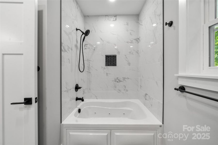 Deep soaking tub in primary in addition to another shower