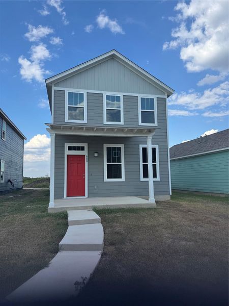 View of front of house featuring a front lawn, a porch, and board and batten siding