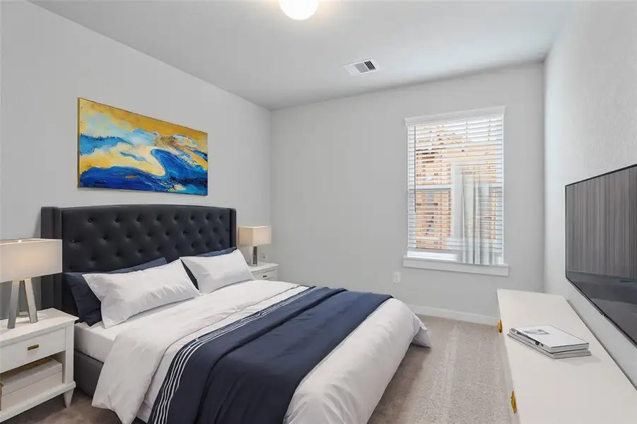 Secondary bedroom features plush carpet, custom paint and a large window.