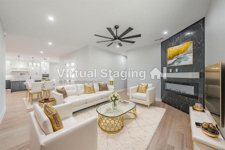 Living area with a premium fireplace, light wood finished floors, recessed lighting, and a ceiling fan