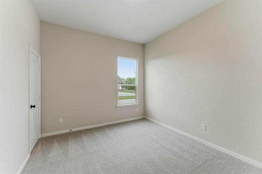 Empty room with light carpet and baseboards