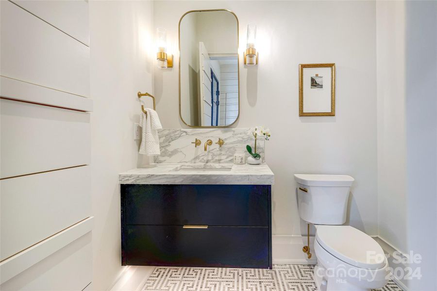 Powder room with floating vanity and accent lighting