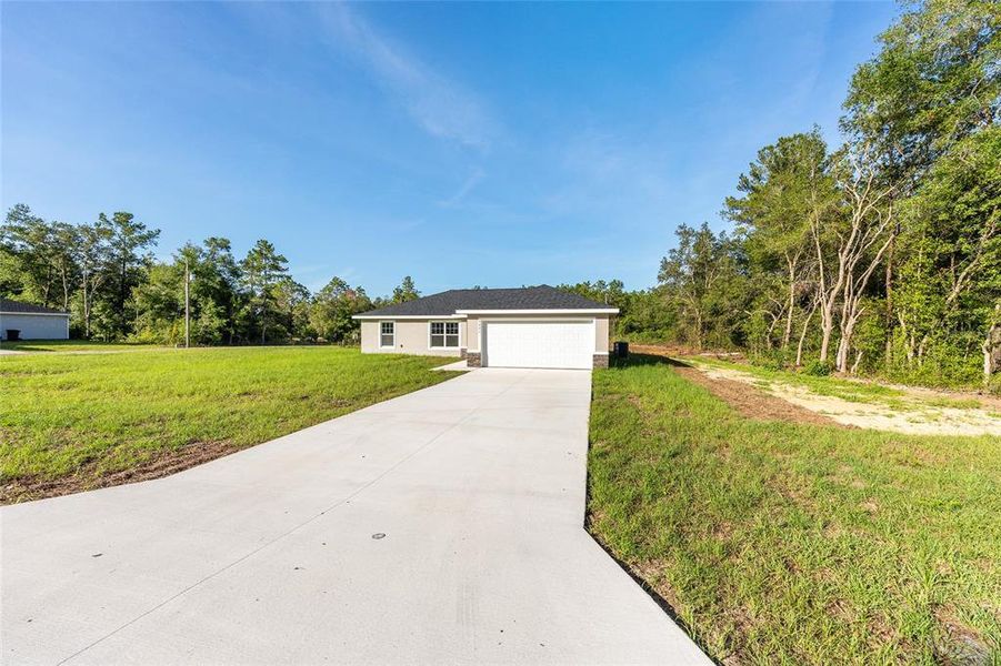 Front exterior of a new home in , Citrus Springs, FL, highlighting curb appeal (Image 2).