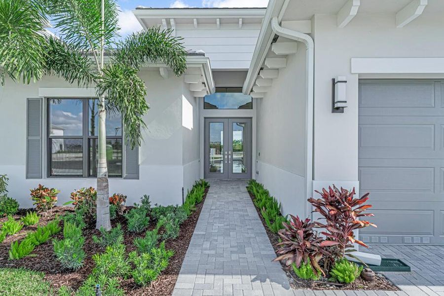 Front exterior of a new home in Apex at Avenir, Palm Beach Gardens, FL, highlighting curb appeal (Image 1). Front exterior of a new home in Apex at Avenir, Palm Beach Gardens, FL, highlighting curb appeal (Image 1).