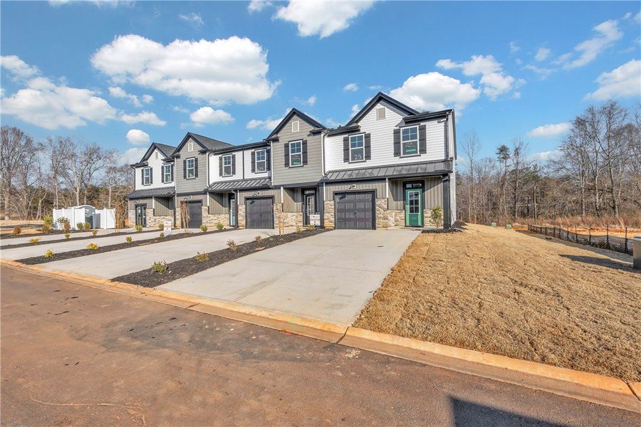 Front exterior of a new home in Meece Townhomes, Easley, SC, highlighting curb appeal (Image 16). Front exterior of a new home in Meece Townhomes, Easley, SC, highlighting curb appeal (Image 16).