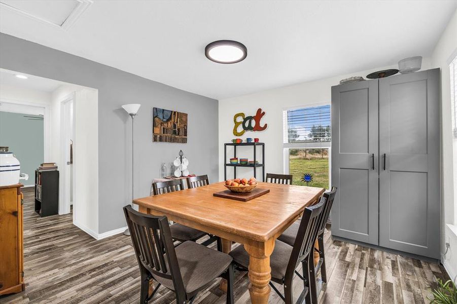 Dining room featuring baseboards and dark wood-style flooring