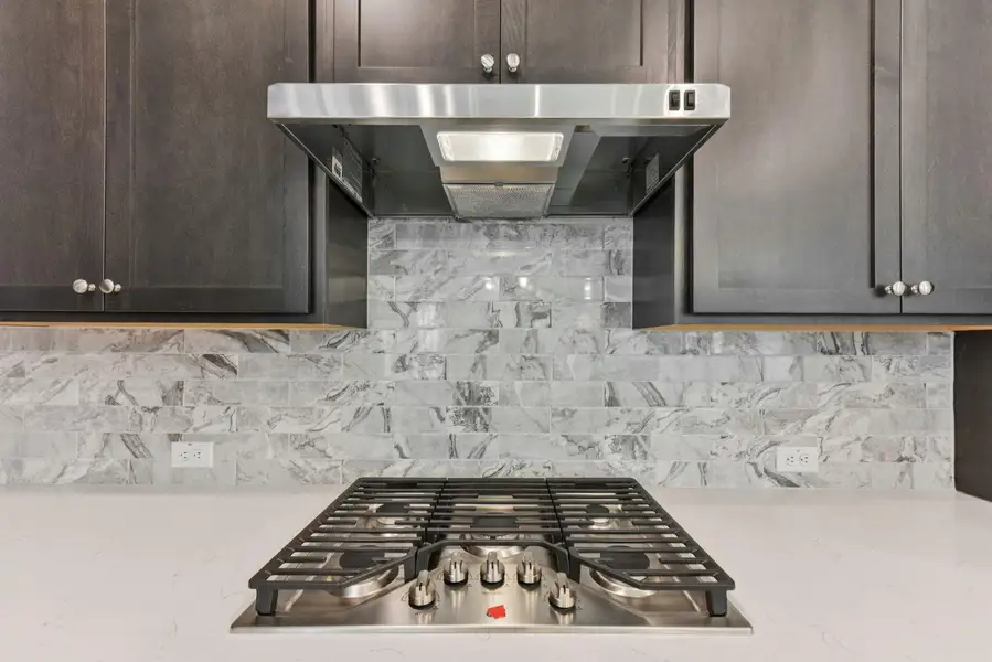 Stainless steel gas cooktop with coordinating range hood