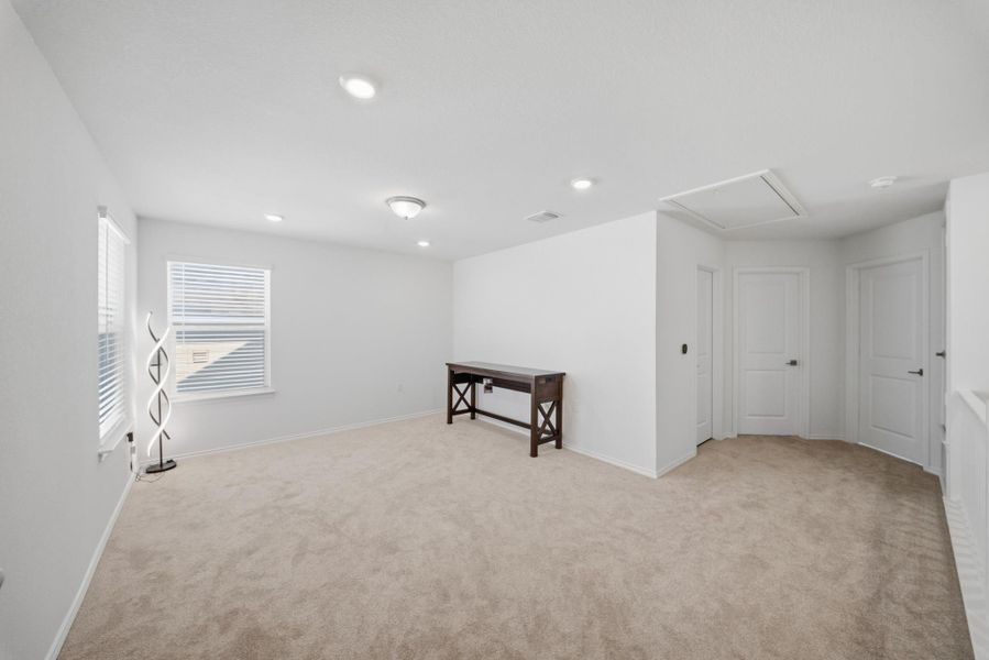 A spacious, naturally illuminated room offers plush carpeting, bright recessed lighting, and ample wall space. A spacious, naturally illuminated room offers plush carpeting, bright recessed lighting, and ample wall space.