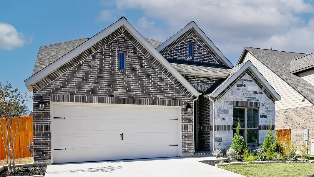 Front exterior of a new home in 6 Creeks 50', Kyle, TX, highlighting curb appeal (Image 2).