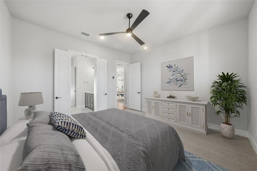 Bedroom featuring light carpet, a ceiling fan, and ensuite bathroom
