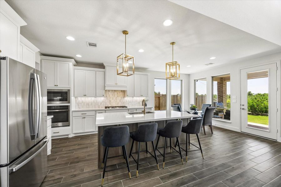 Oversized island with seating anchors this bright kitchen