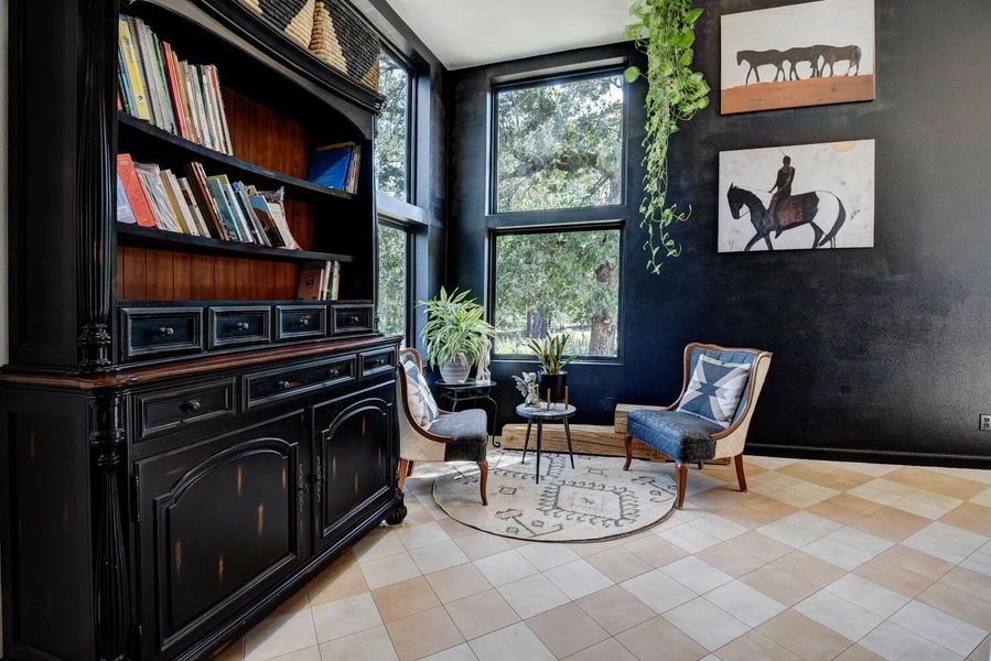 Living area with light tile patterned floors and baseboards Living area with light tile patterned floors and baseboards