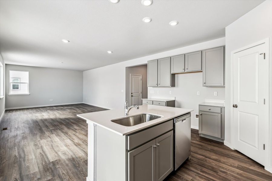 A kitchen with white cabinets.