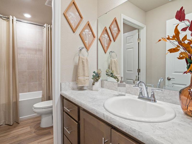 The upstairs hall bath serves the secondary bedrooms - Mariposa townhome by Highland Homes