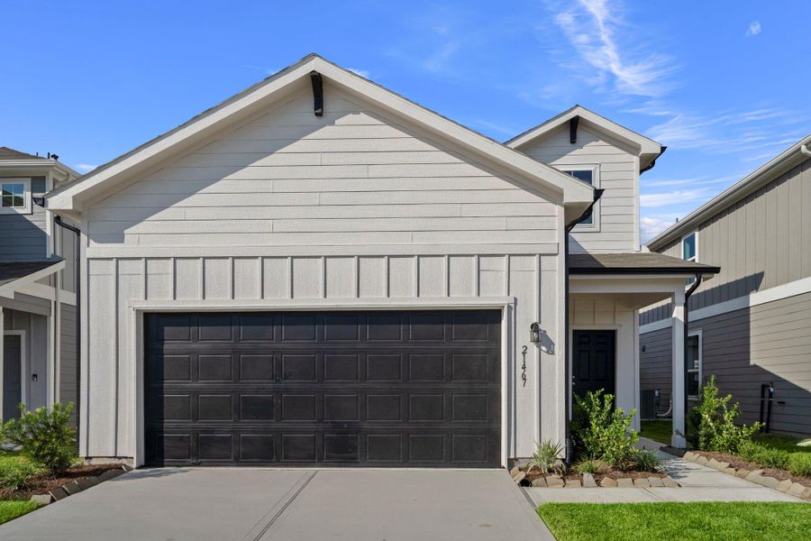 Front exterior of a new home in Peppervine, Porter, TX, highlighting curb appeal (Image 2). Front exterior of a new home in Peppervine, Porter, TX, highlighting curb appeal (Image 2).