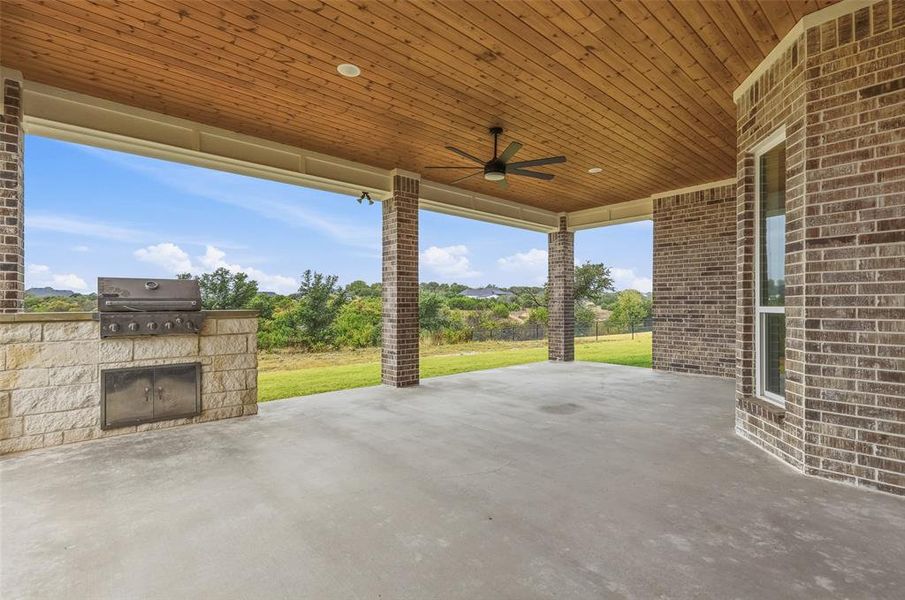 View of patio with ceiling fan and area for grilling View of patio with ceiling fan and area for grilling