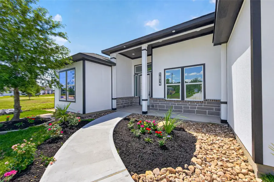 Inviting modern farmhouse exterior with clean architectural lines, charming curb appeal, and thoughtfully designed landscaping.