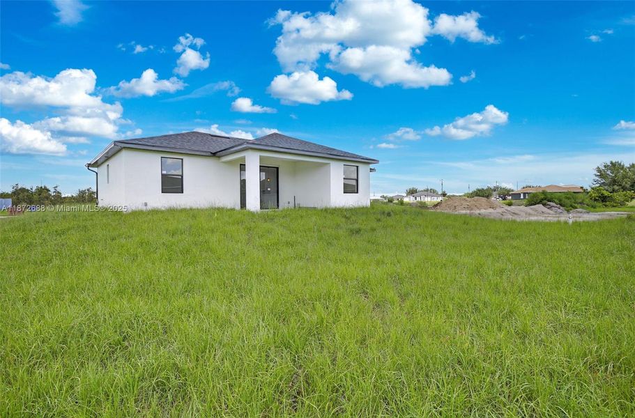 Front exterior of a new home in , Lehigh Acres, FL, highlighting curb appeal (Image 16).