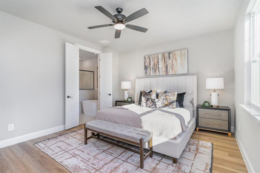 Bedroom featuring ceiling fan, wood-type flooring, and connected bathroom