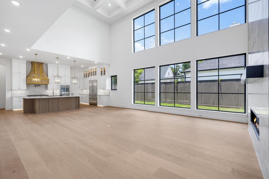 As you walk through, you enter the great room that features 23ft ceilings, 6 custom European windows that shine plenty of natural light.