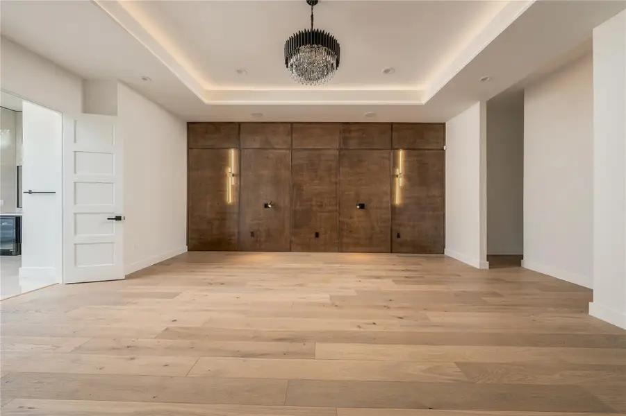Primary Bedroom with Custom Wood Accents and Lighting