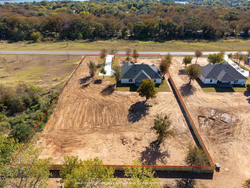 Aerial overview of property's location with property parcel outlined and a heavily wooded area