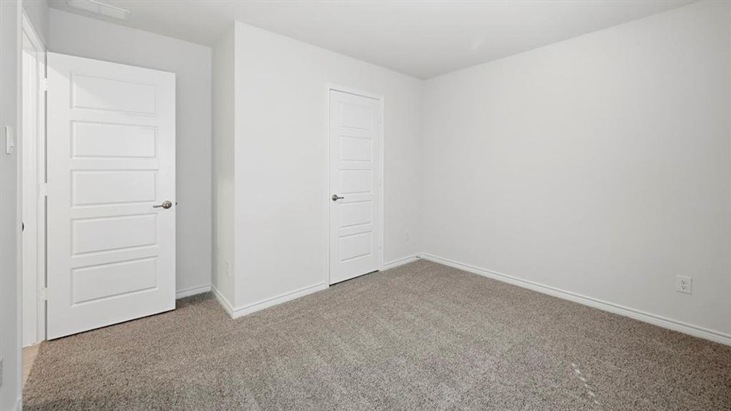 Unfurnished bedroom with carpet floors and baseboards