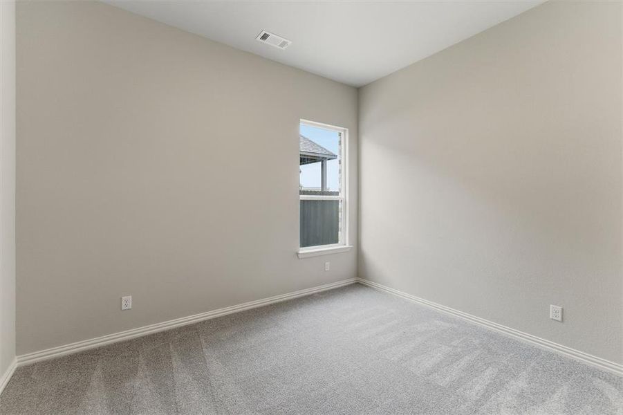 Empty room with light carpet and baseboards