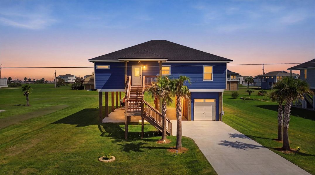 Elevated coastal home with charming blue exterior. Elevated coastal home with charming blue exterior.