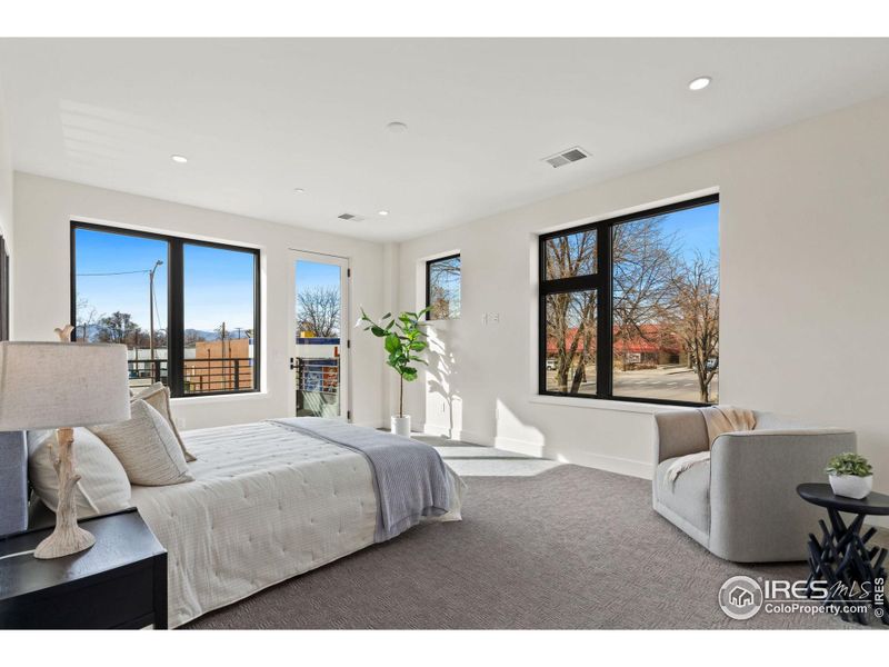 Large primary bedroom with views and a walkout to your own private balcony to take in the morning light