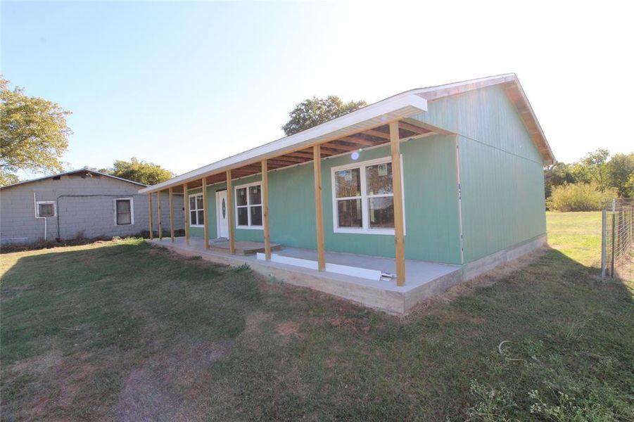 Rear view of property featuring a yard Rear view of property featuring a yard