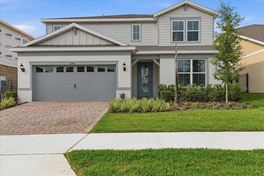 Front exterior of a new home in Willow Ridge, Montverde, FL, highlighting curb appeal (Image 1). Front exterior of a new home in Willow Ridge, Montverde, FL, highlighting curb appeal (Image 1).