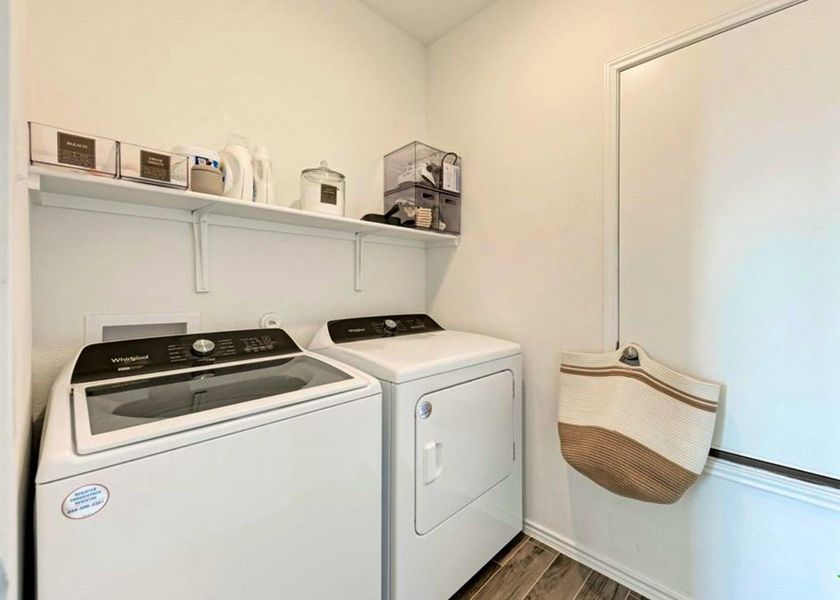 Washroom featuring dark wood-type flooring and washing machine and dryer Washroom featuring dark wood-type flooring and washing machine and dryer