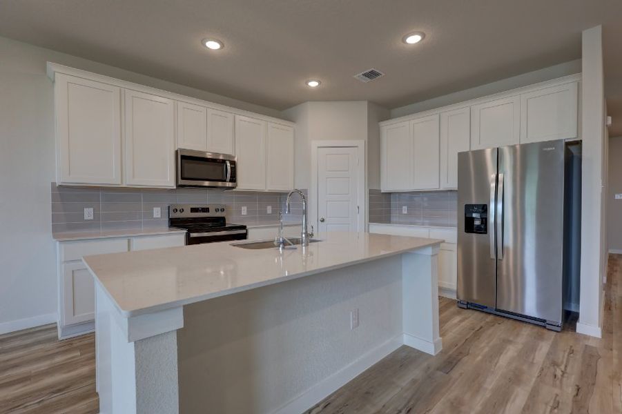 A kitchen with white cabinets. A kitchen with white cabinets.