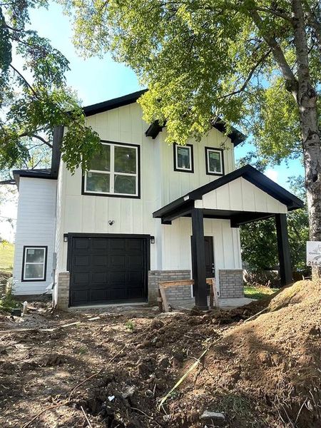 View of front facade featuring a garage