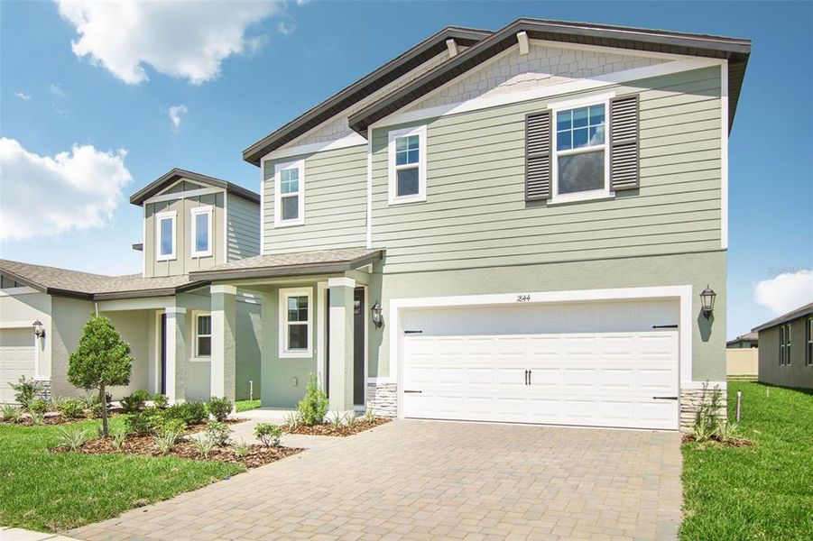 Front exterior of a new home in Two Rivers - Premier Series, Zephyrhills, FL, highlighting curb appeal (Image 14). Front exterior of a new home in Two Rivers - Premier Series, Zephyrhills, FL, highlighting curb appeal (Image 14).