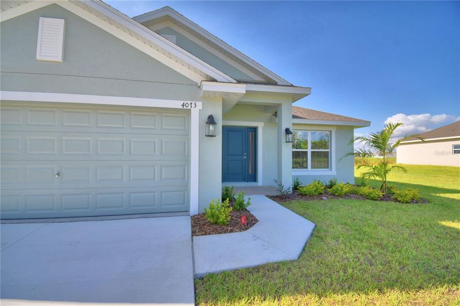 Front exterior of a new home in Cadence Crossing, Auburndale, FL, highlighting curb appeal (Image 2).