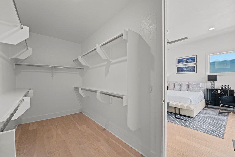 Spacious walk-in closet featuring custom shelving and abundant storage.